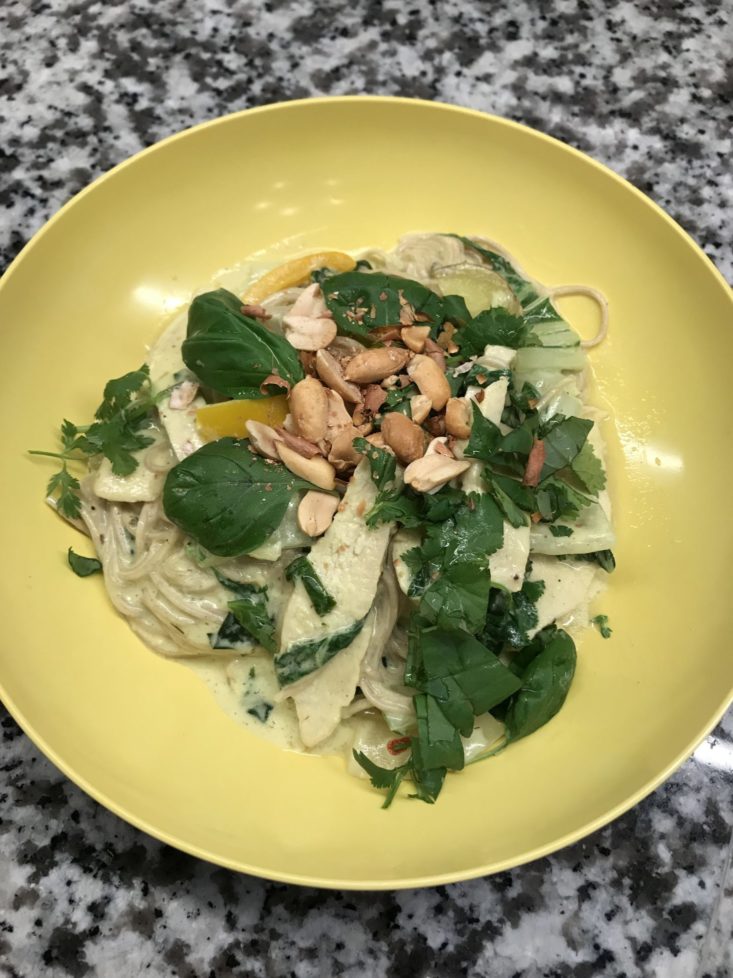 Completed meal of lemongrass curry with fresh cilantro and basil