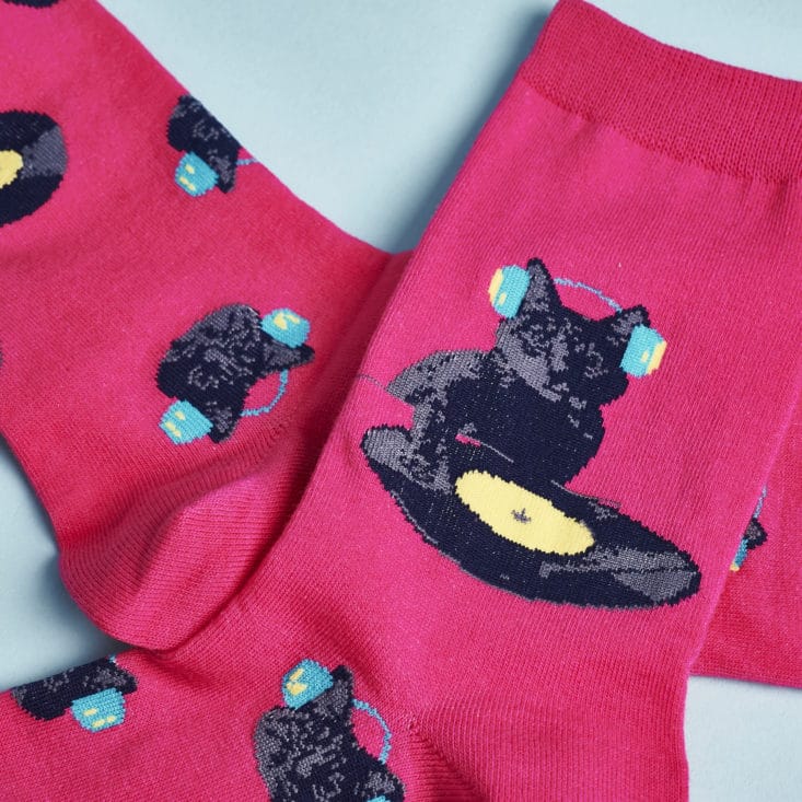 Detail of socks showing cat wearing headphones and scratching on a record