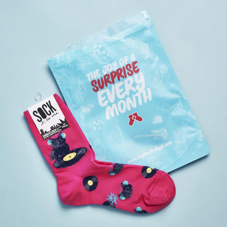 The pink cat socks we received plus the blue shipping bag.
