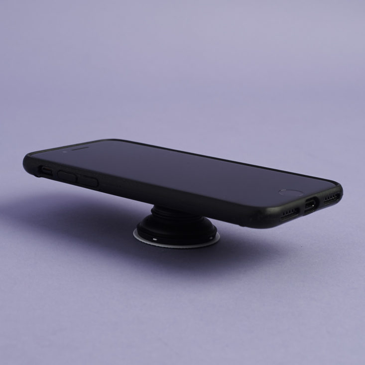 iphone resting on Popsockets phone grip and stand
