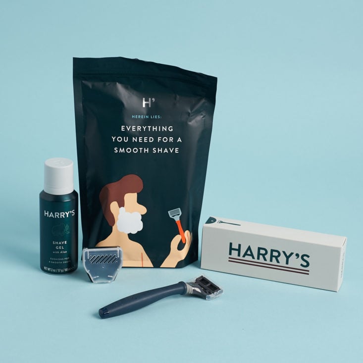 Harry's razor starter kit with blue handle, shave gel, and travel case on a blue background