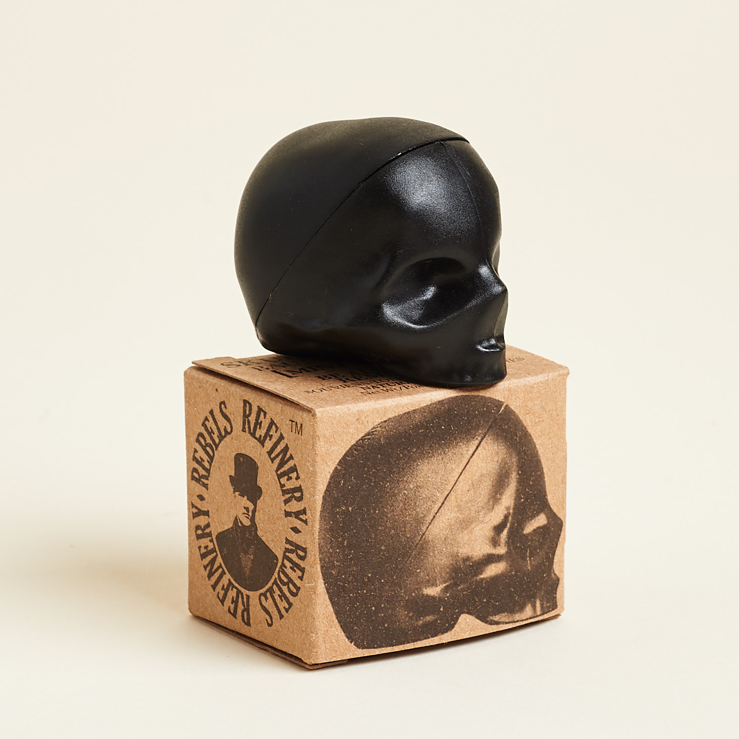 black skull lipstick casing sitting on top of kraft box