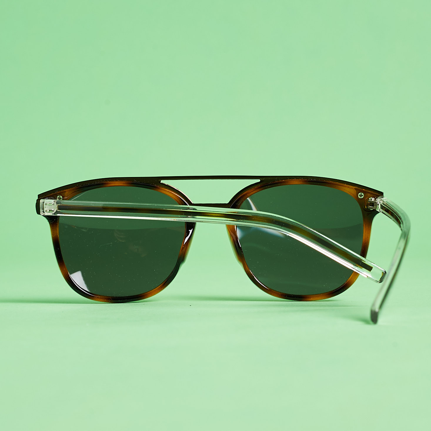 back and arm of Shades Club tortoise sunglasses
