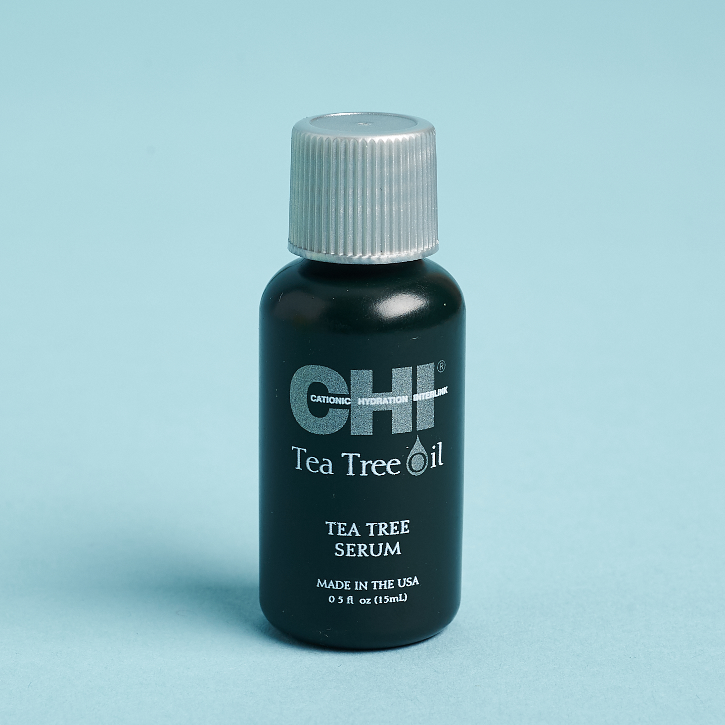 small black bottle of chi tea tree serum