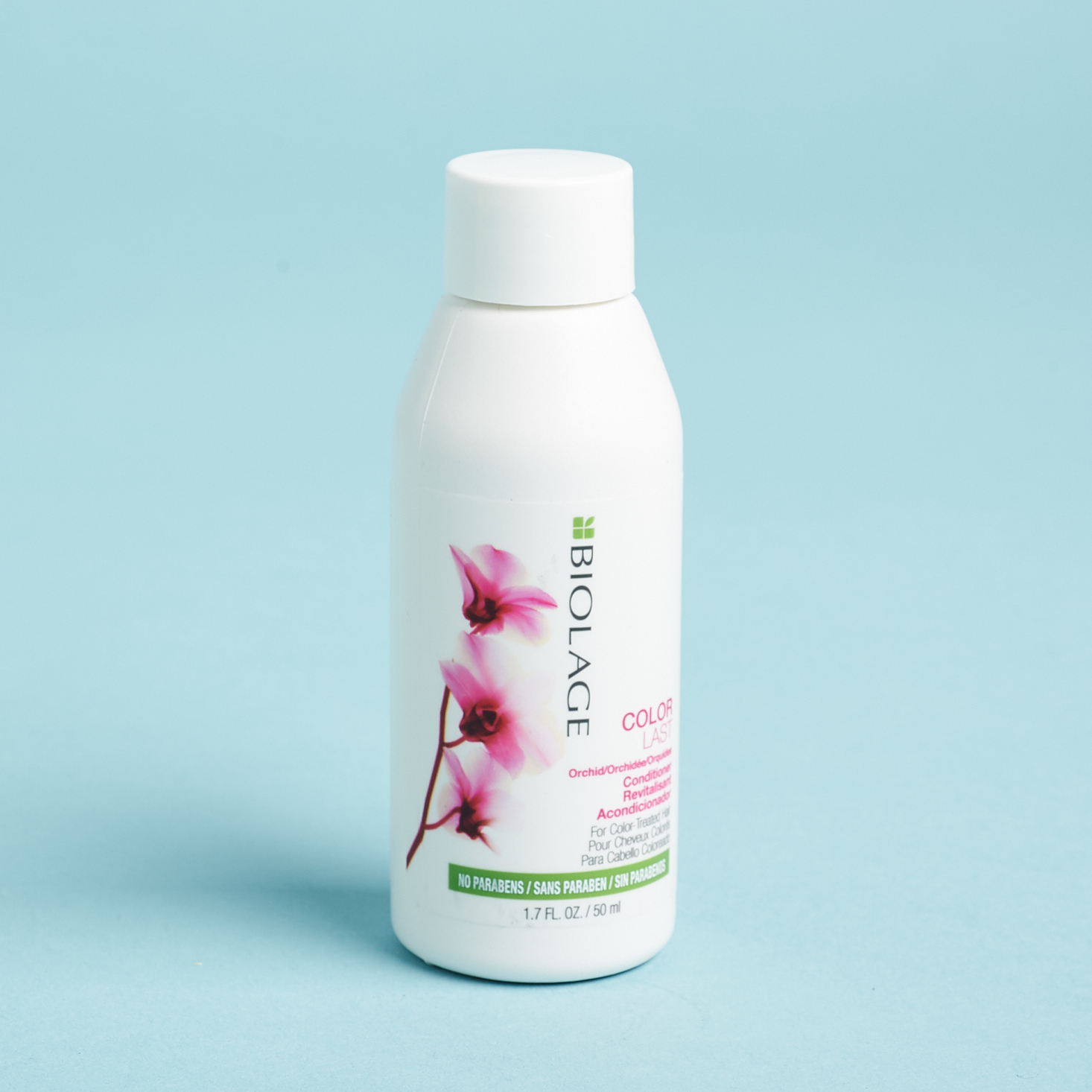 white bottle of conditioner with pink flowers