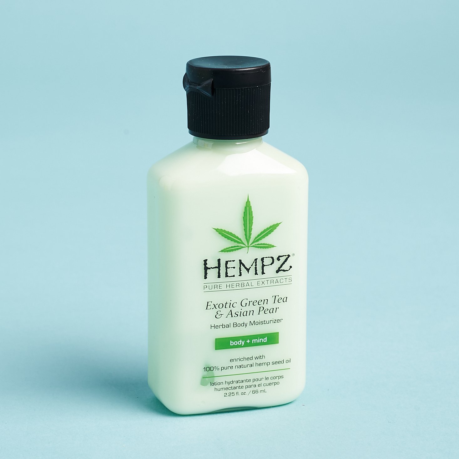 green lotion in clear bottle with black cap