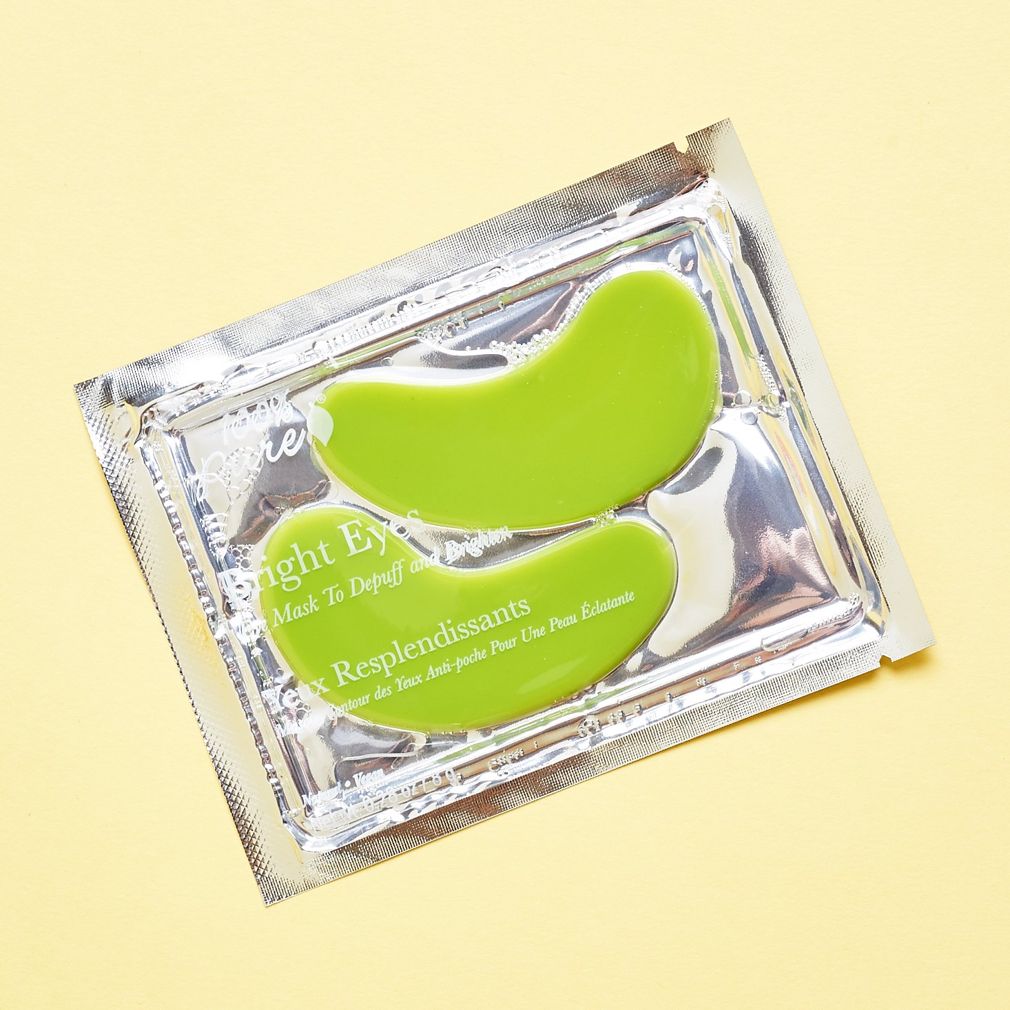 clear and foil packet of lime green eye pads