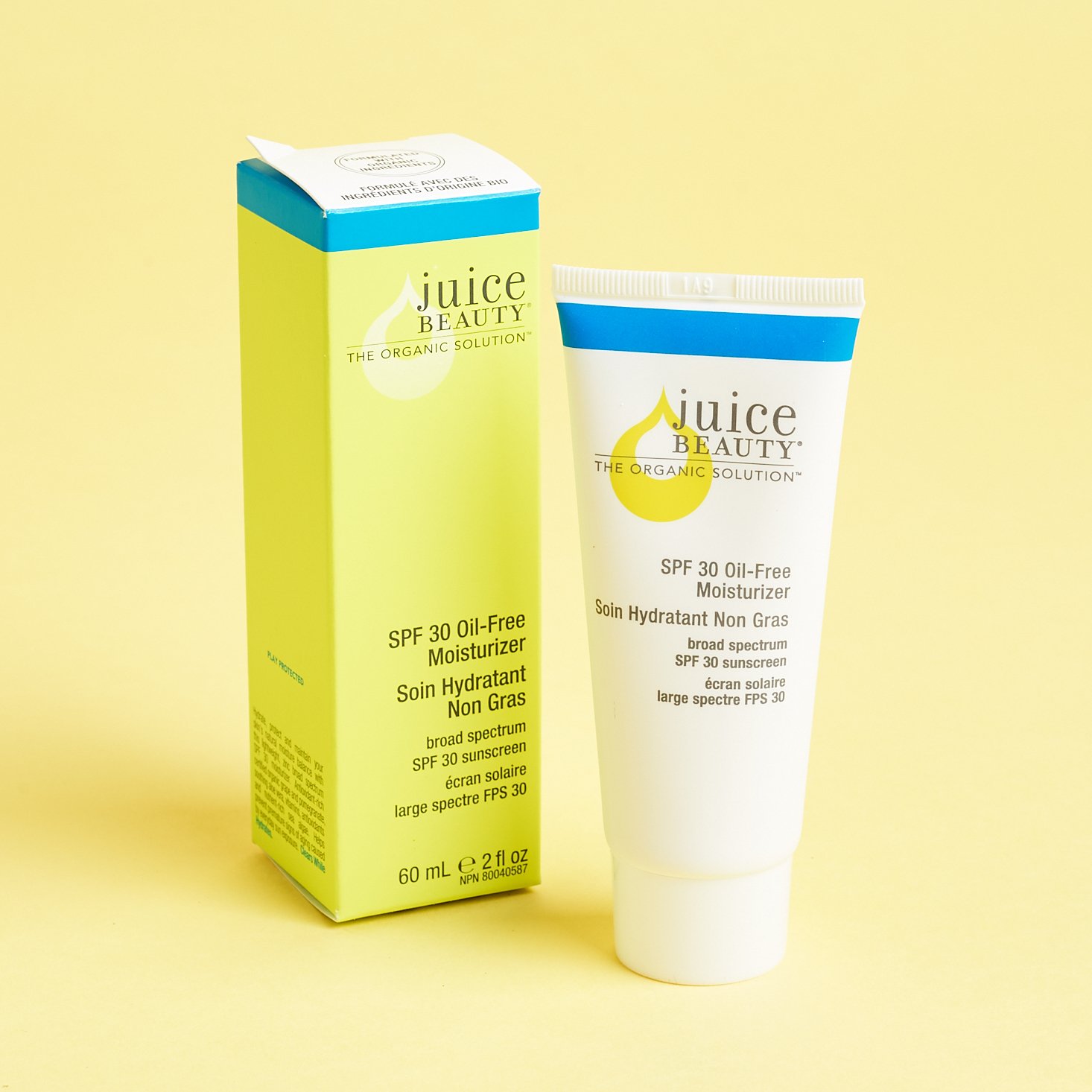 tube of juice moisturizer with blue and green graphics on white background