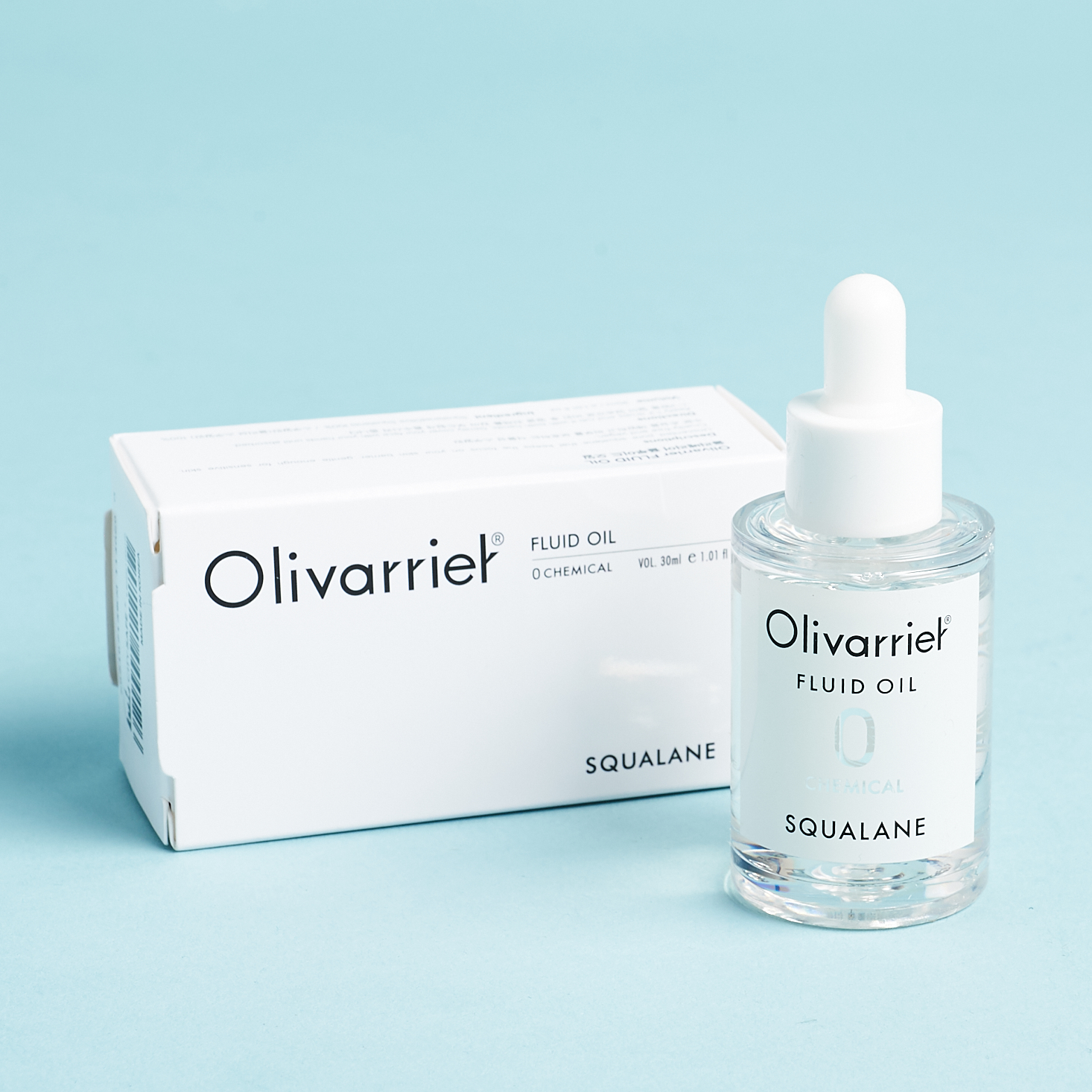 white box with olivarriel branding beside clear bottle of oil