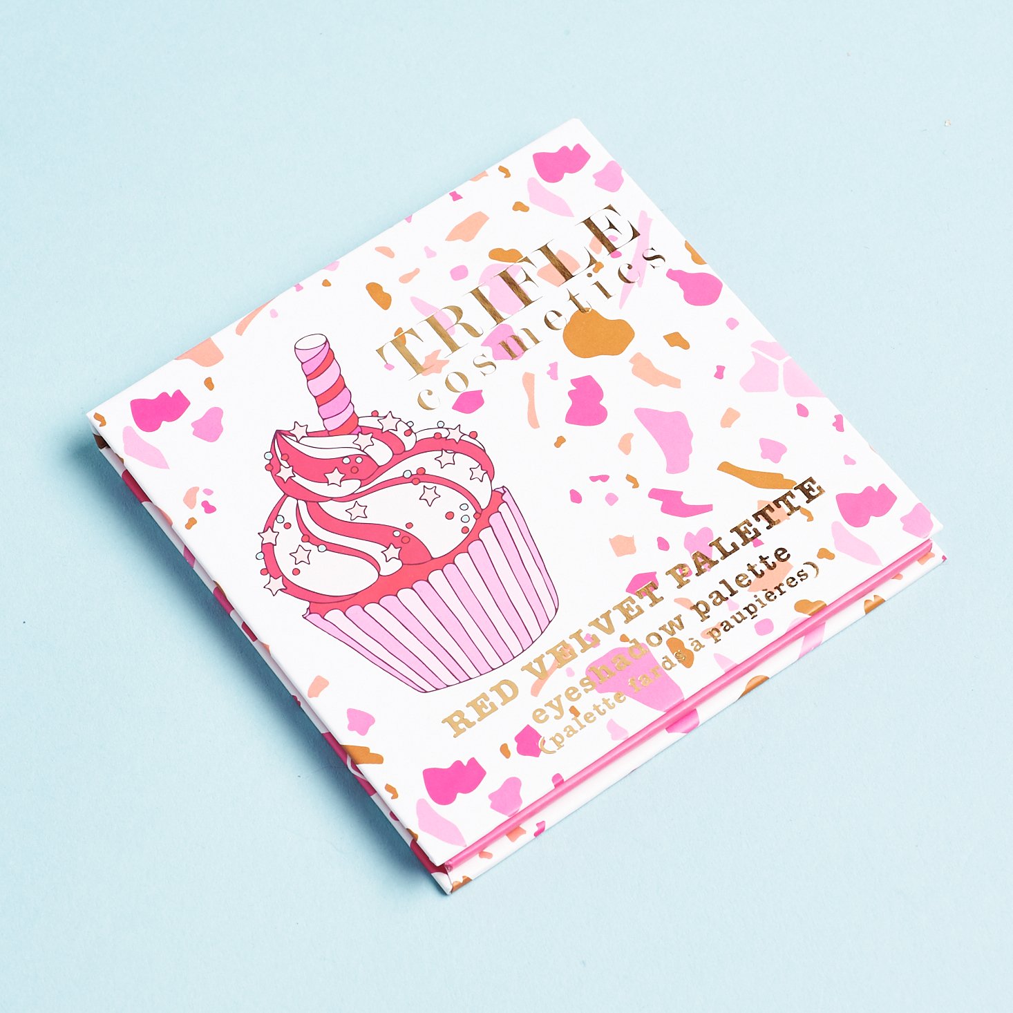 lid of eyeshadow palette with red pink and white cupcake design