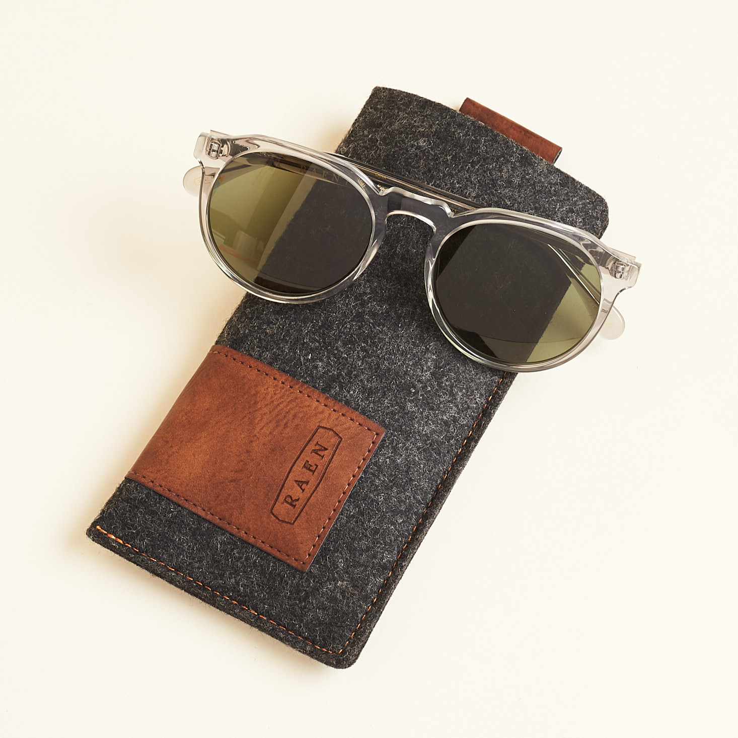 raen sunglasses sitting on grey felted case