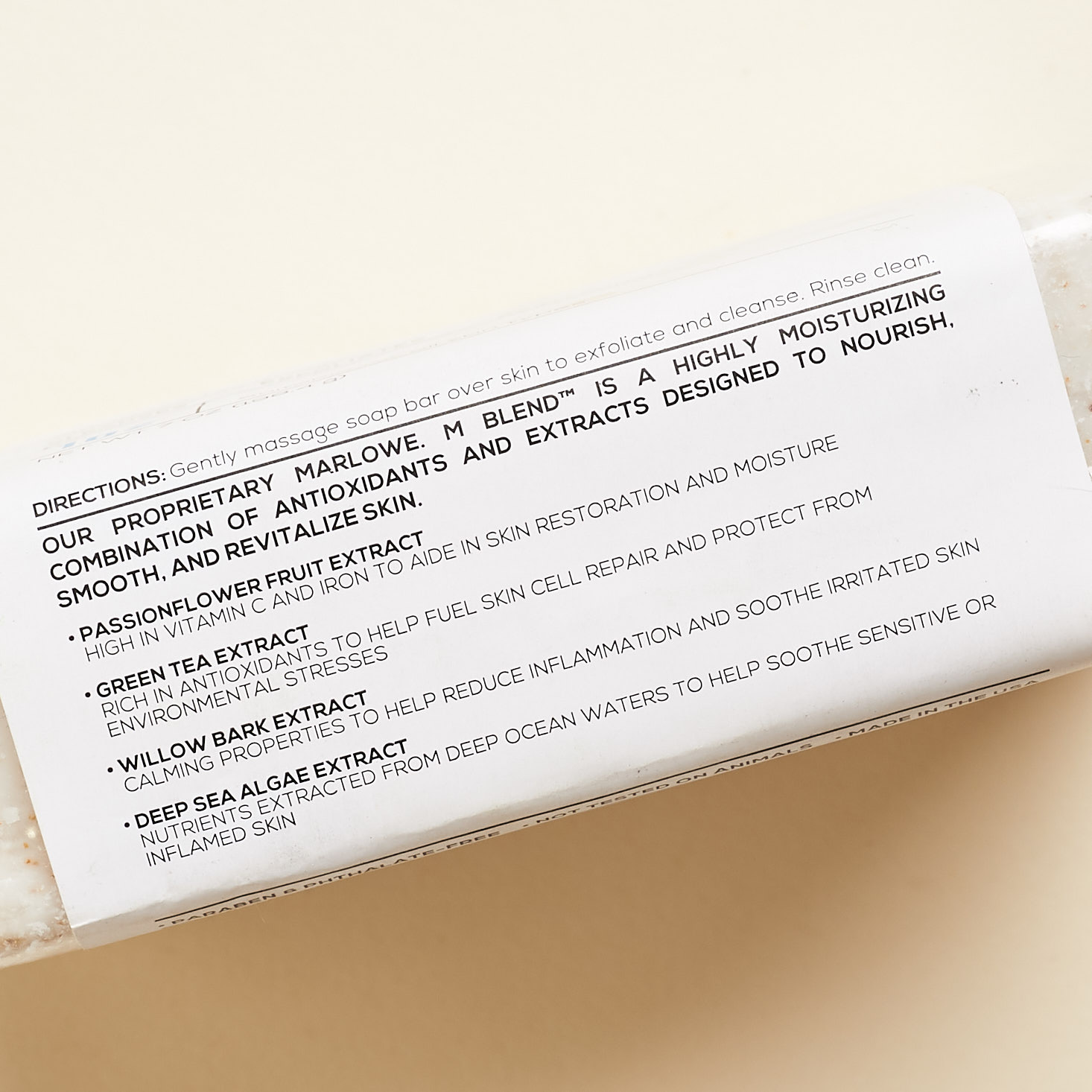 side of soap bar with label showing featured ingredients