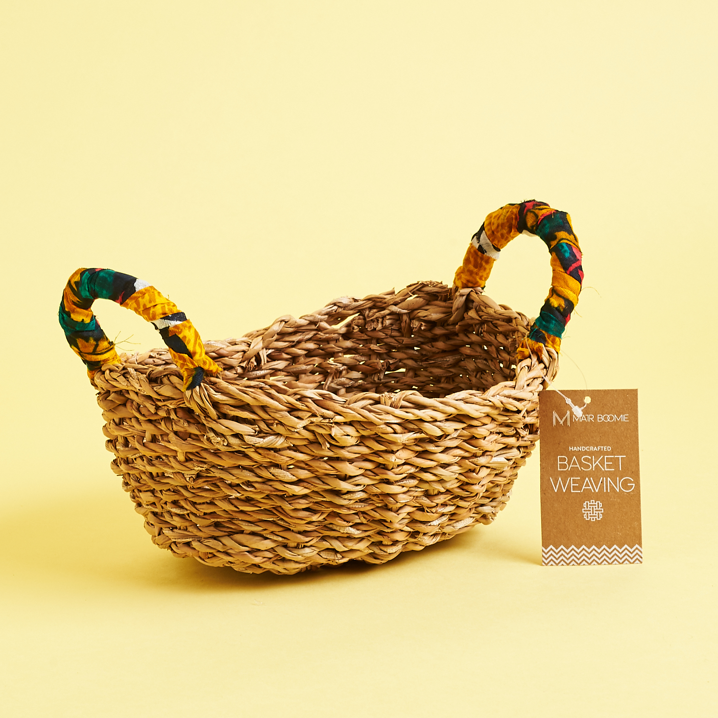 handwoven basket with colorful fabric covered handles