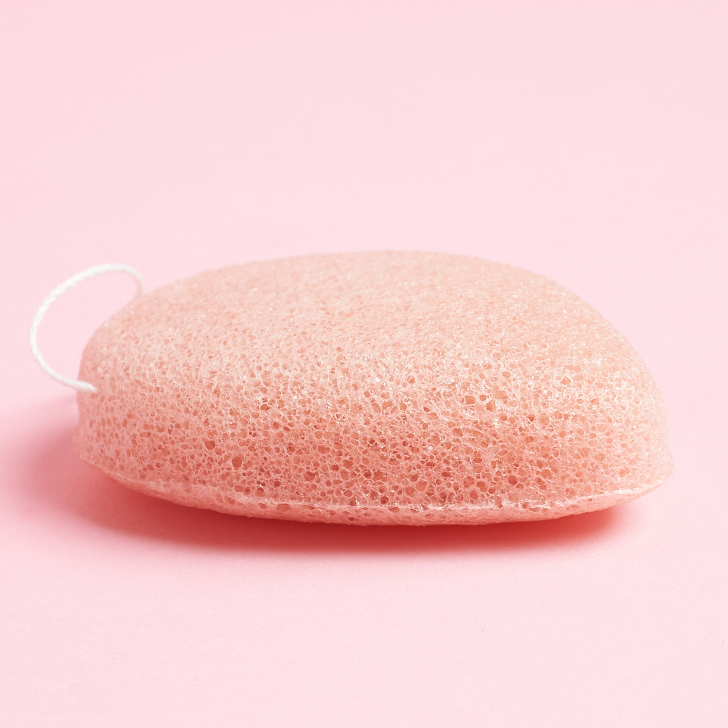 side view of BKind Pink Clay Konjac Facial Sponge to show thickness