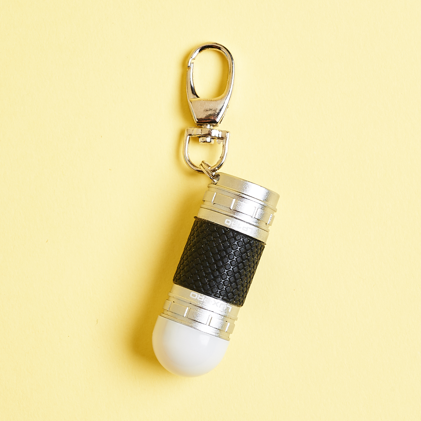 black and silver keychain light with white bulb tip