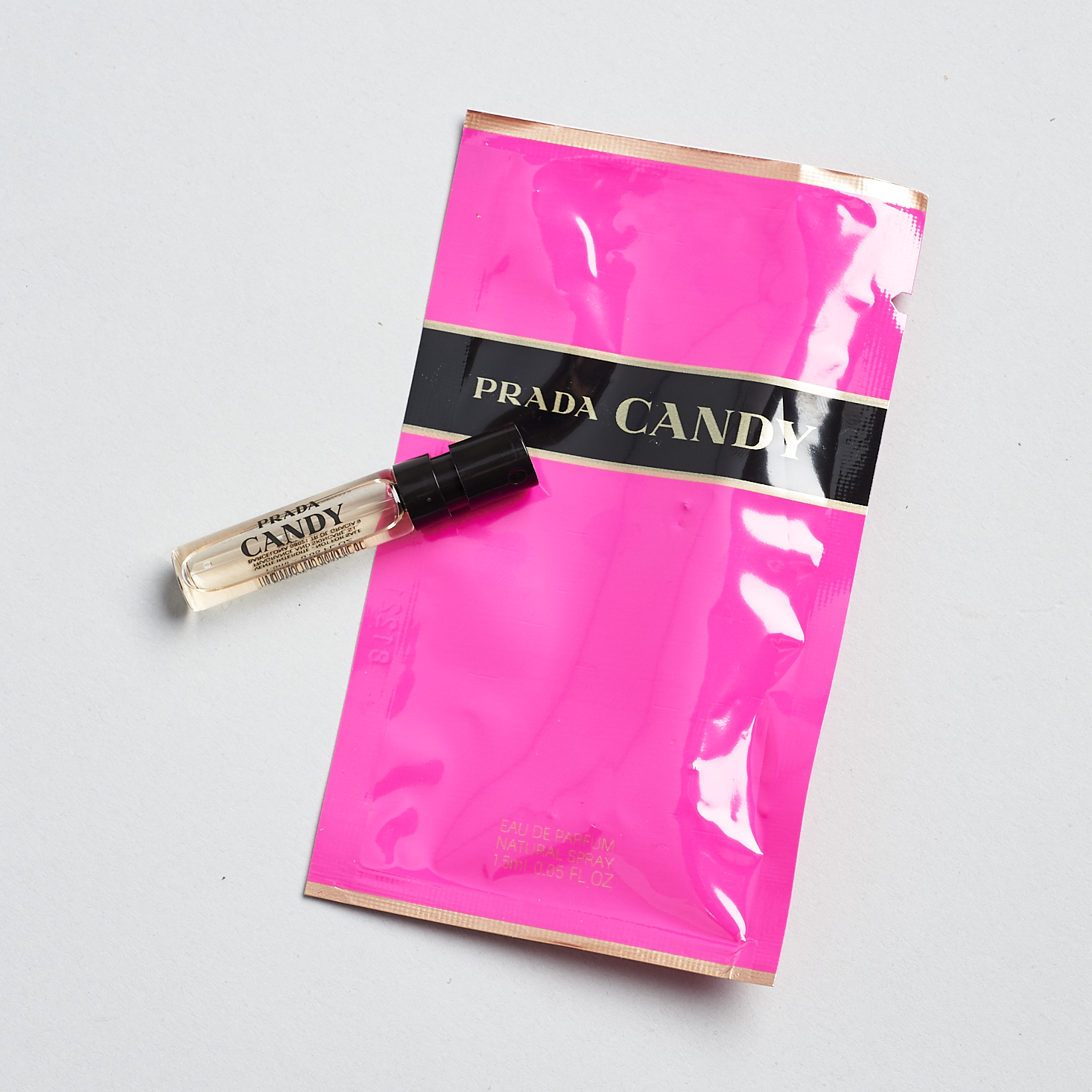 hot pink prada candy packaging with small perfume vial