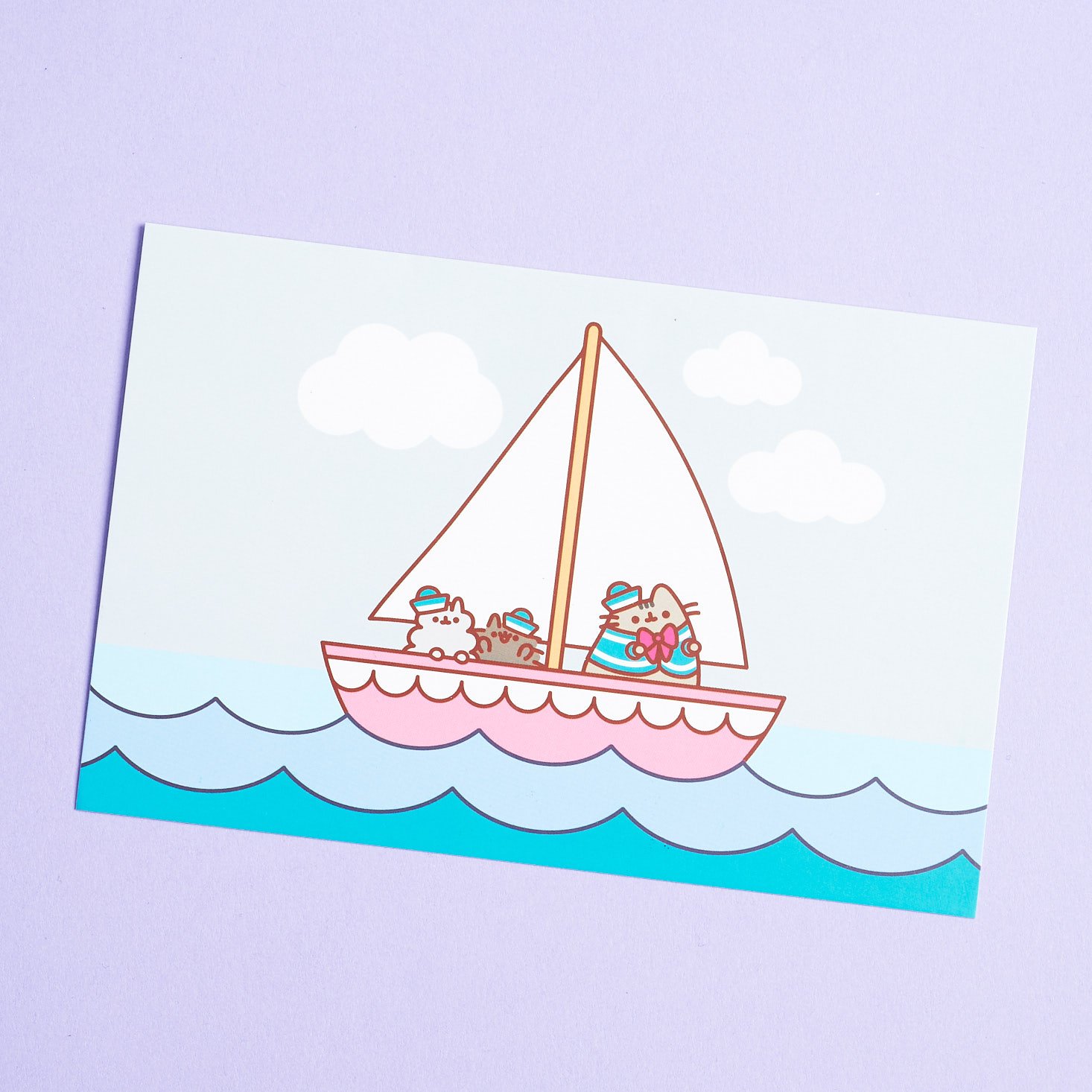 Front of info card featuring Pusheen and friends on a sail boat