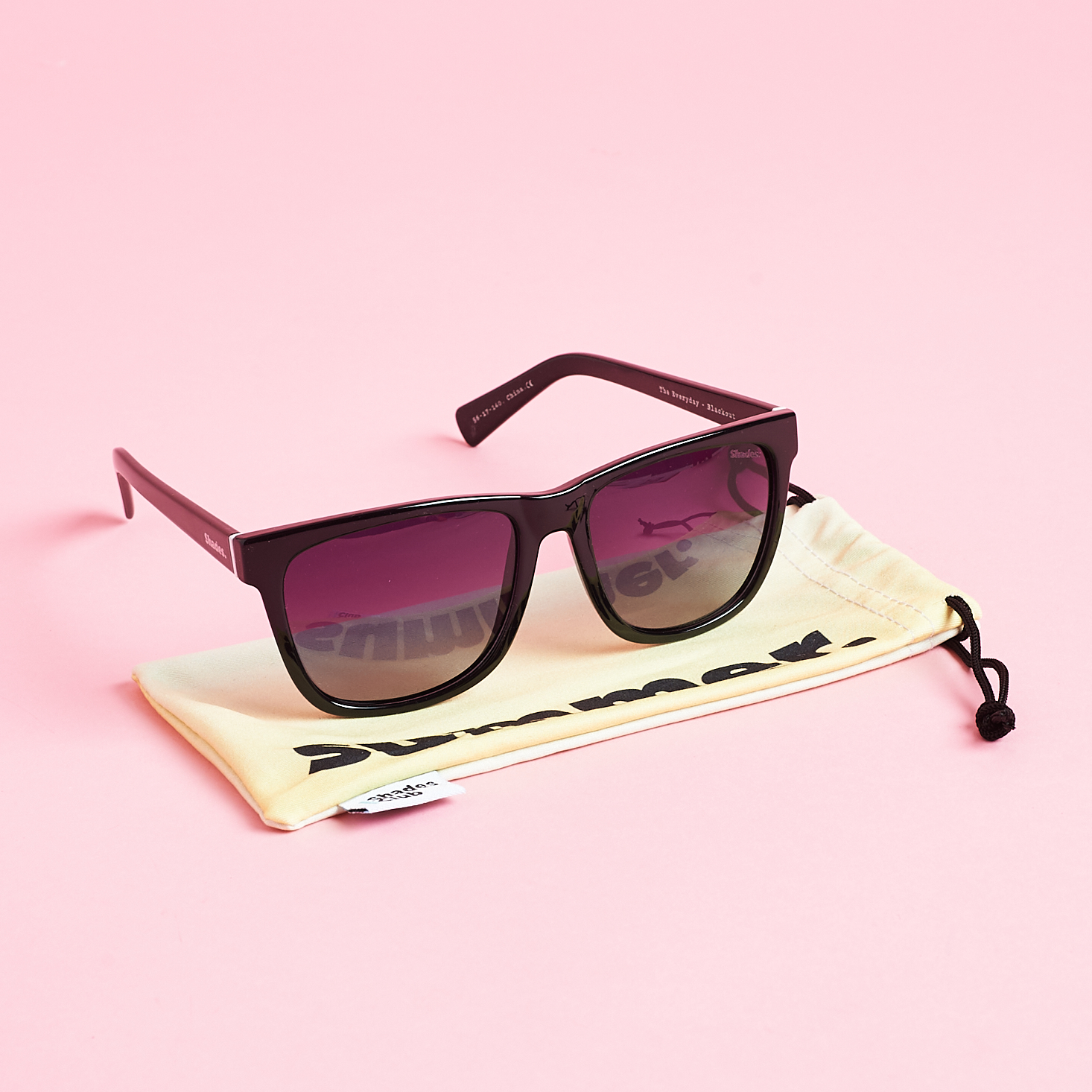 Everday style sunglasses on top of yellow pouch