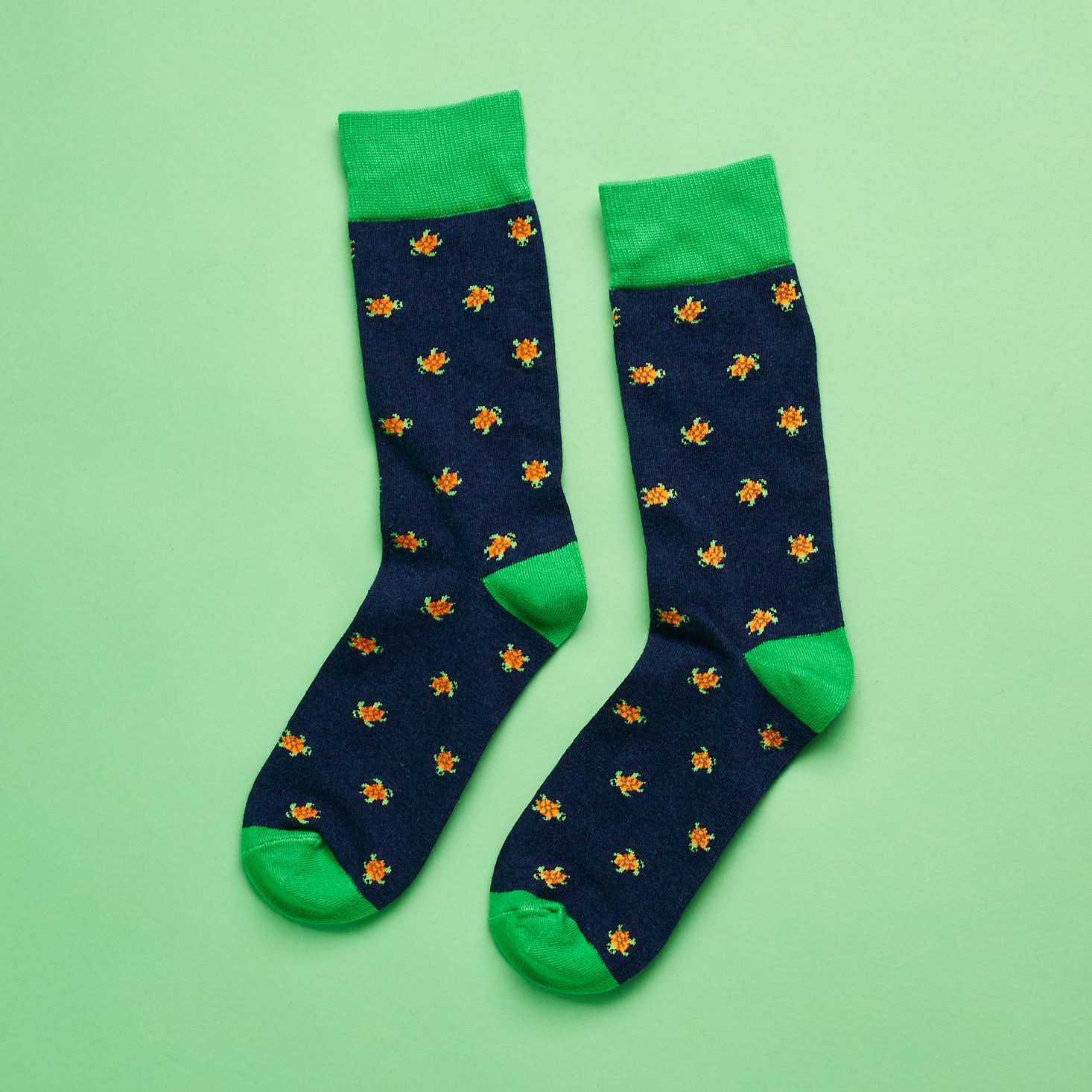 navy socks with small green turtles on them and green edges