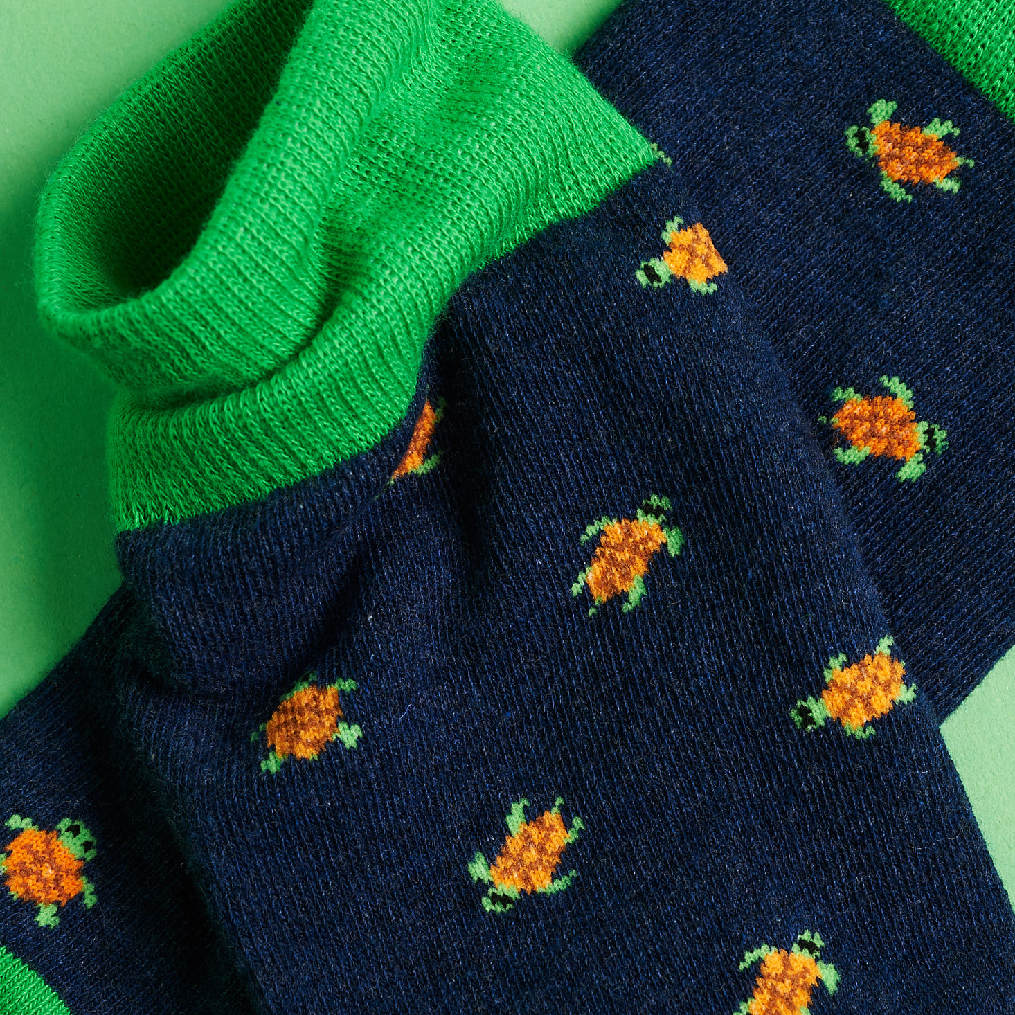 close up on the turtle designs and green cuffs of the socks