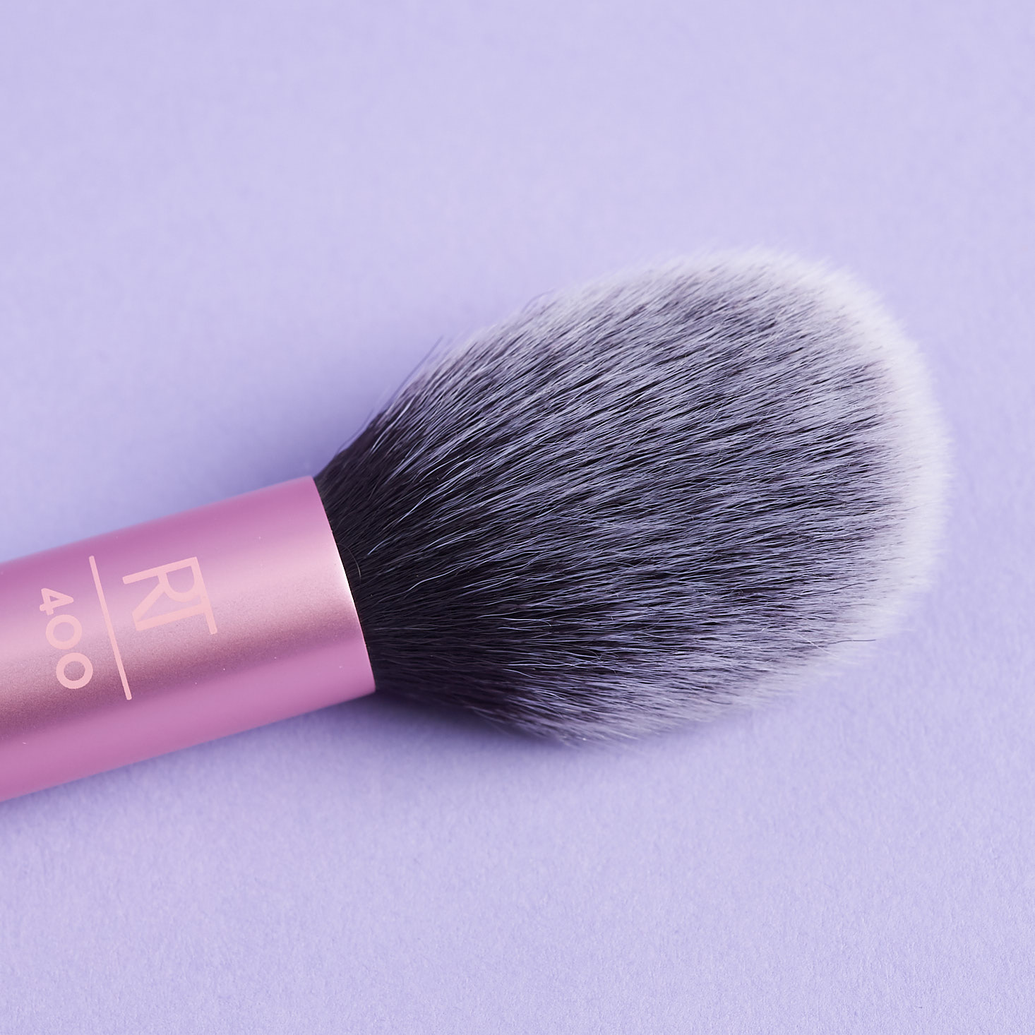 close up of Real Techniques pink metal blush brush head