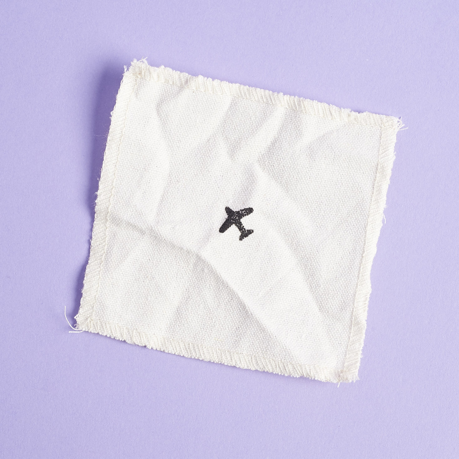 linen coaster with airplane icon
