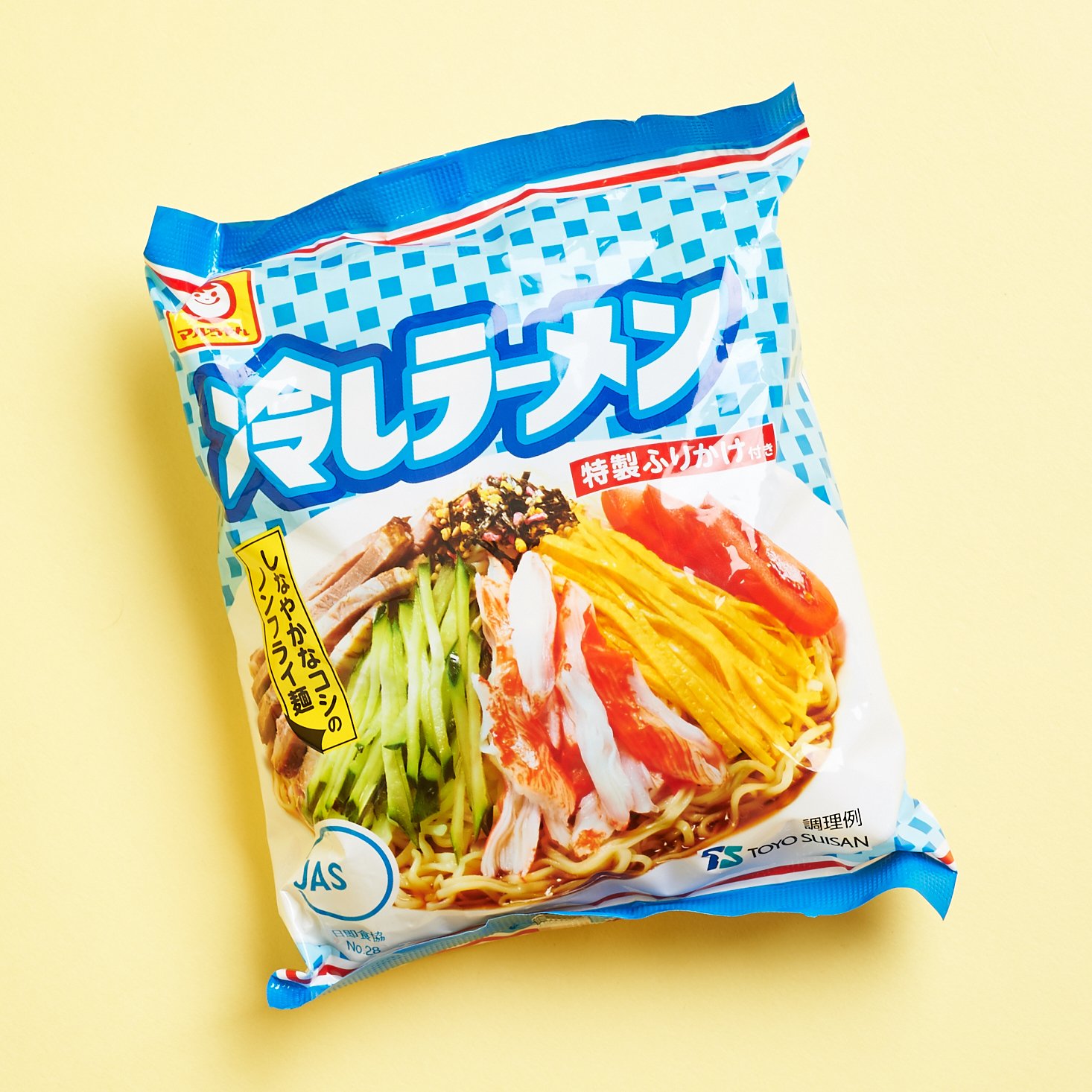 cold ramen pictured as a laydown with vibrant blue packaging and a photo of the finished meal