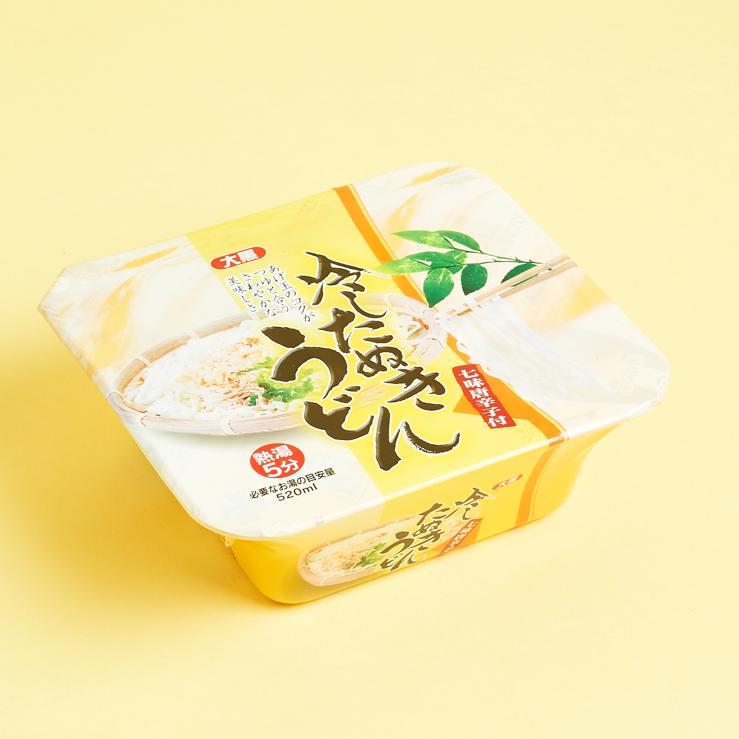 unopened cold tanuki udon package with a yellow design and fancy hiragana