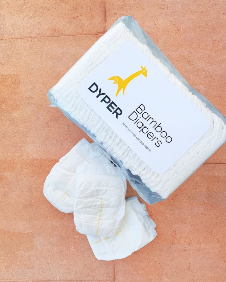 dyper diaper subscription plain bamboo diapers in pack and laying beside them