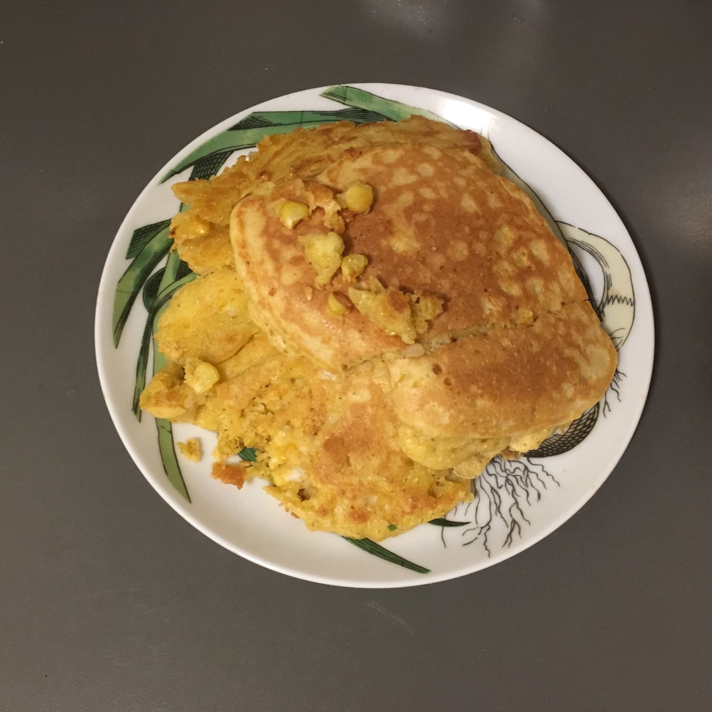 cajun shrimp and corn pancakes on a plate cooling