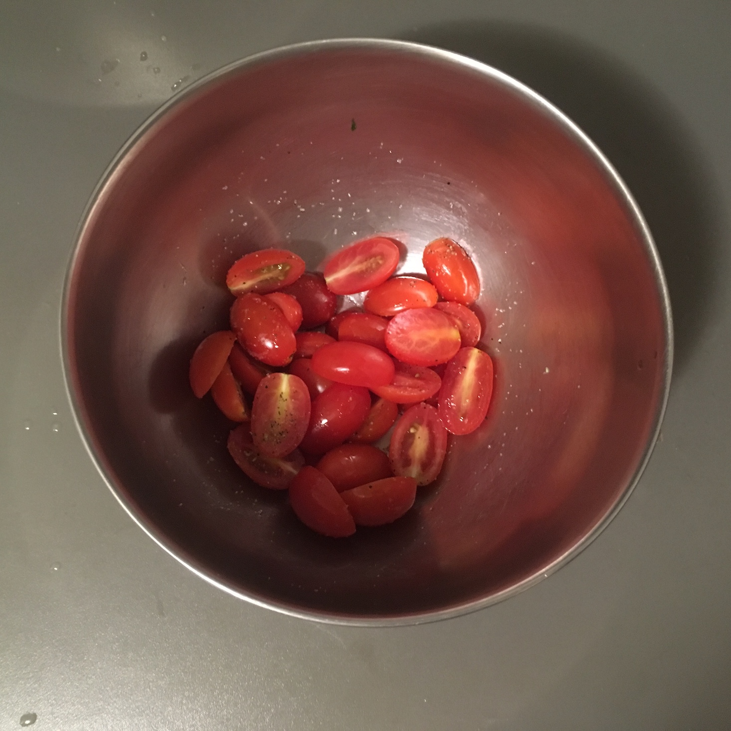 cajun shrimp and corn pancakes sliced cherry tomatoes in a bowl