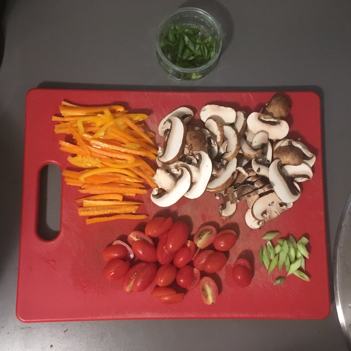 spicy egg and vegetable skillet sliced veggie prep work on a cutting board