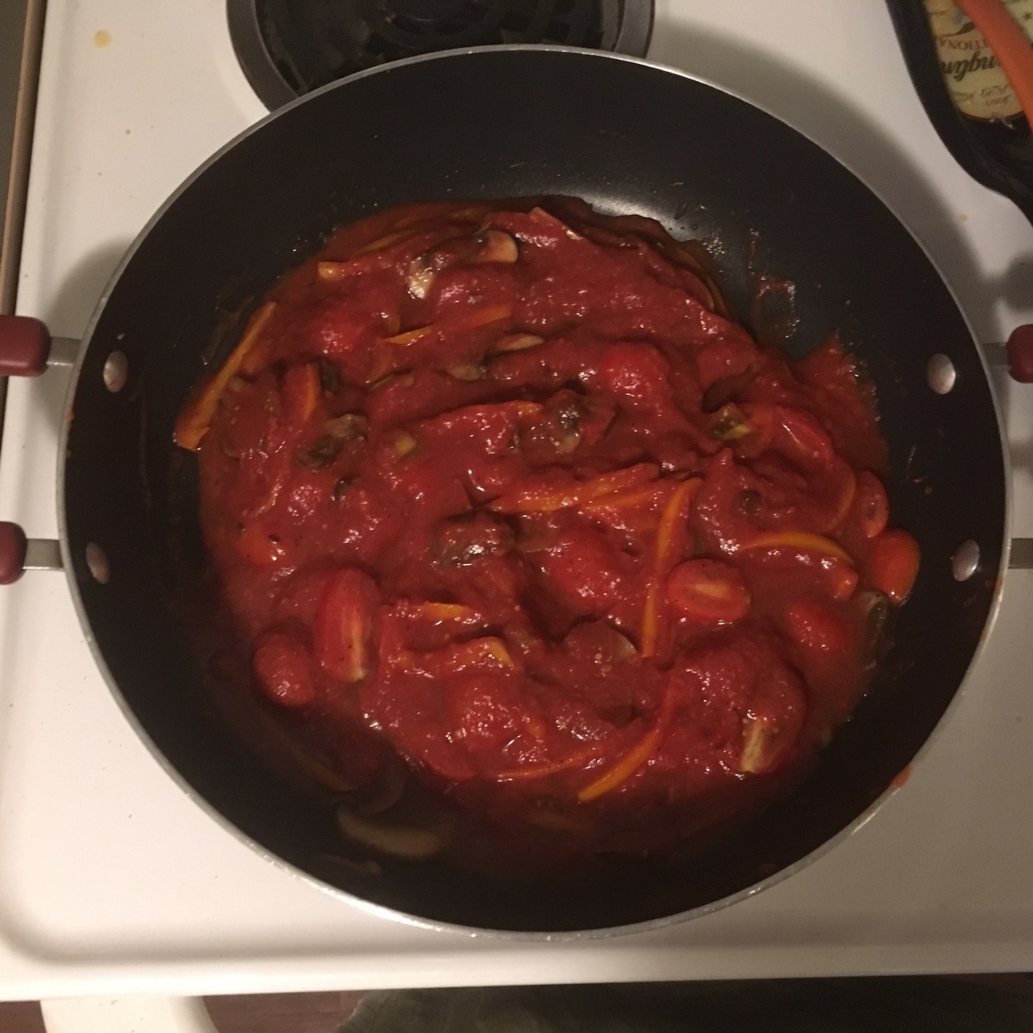 spicy egg and vegetable skillet tomato sauce and gochujang added to veggies in the pan