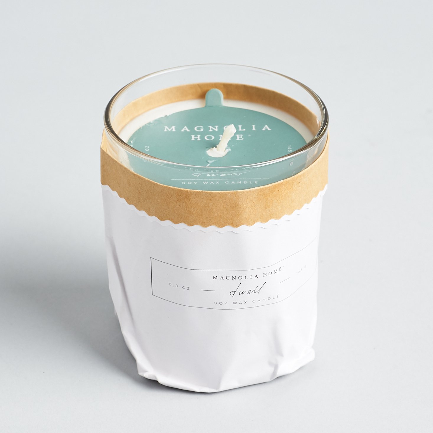 candle in fancy white paper bag