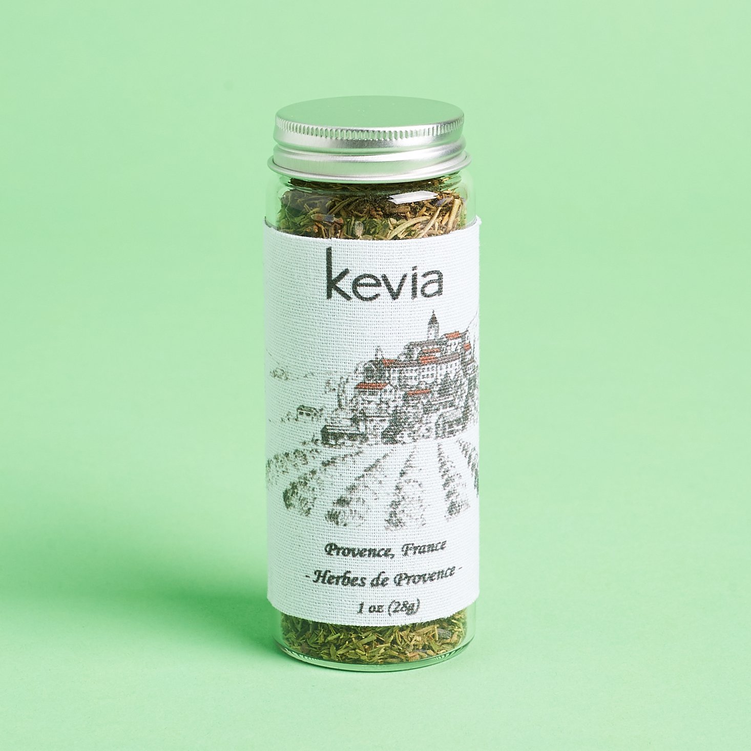 glass bottle of herbs with silver lid