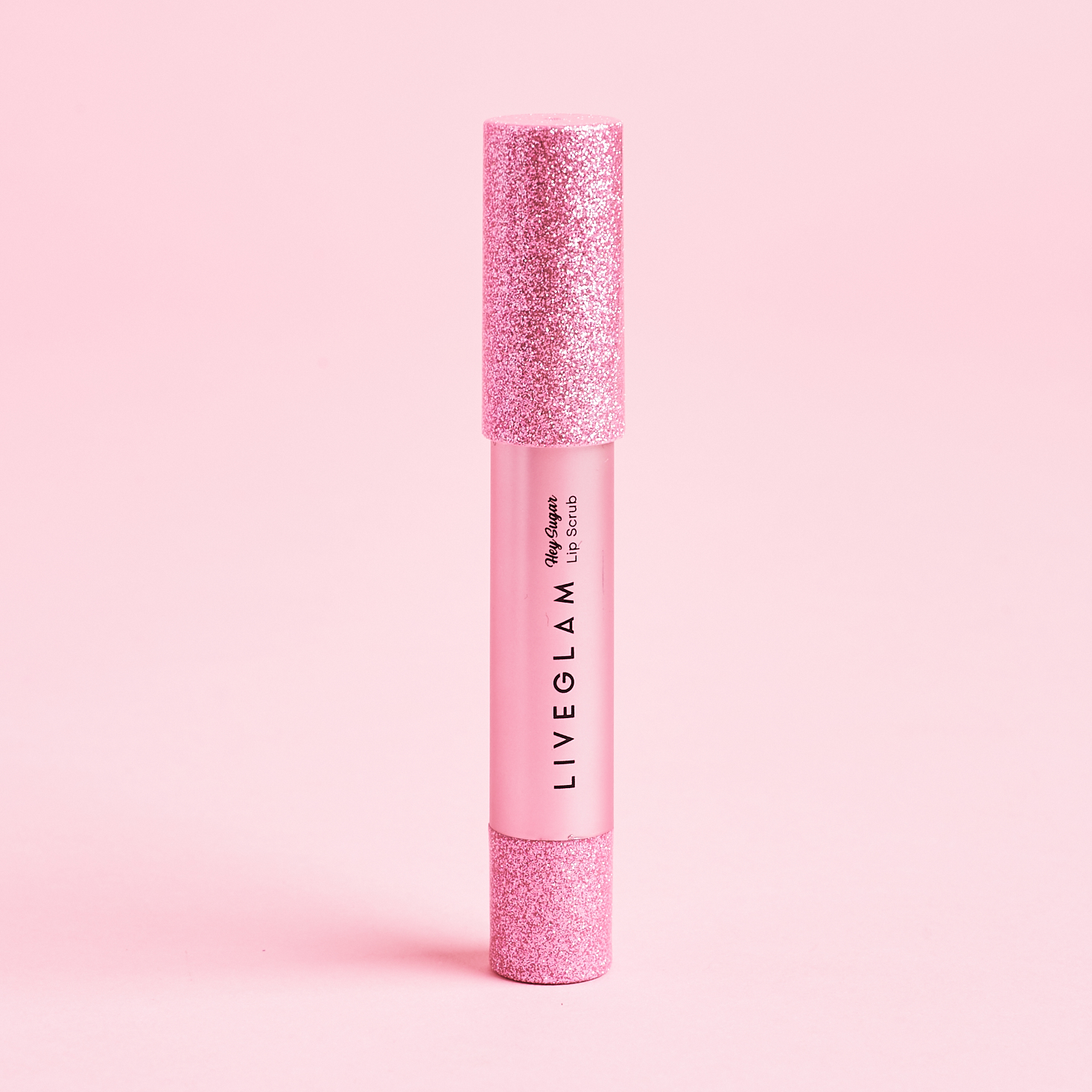 pink and glitter covered tube of lip scrub