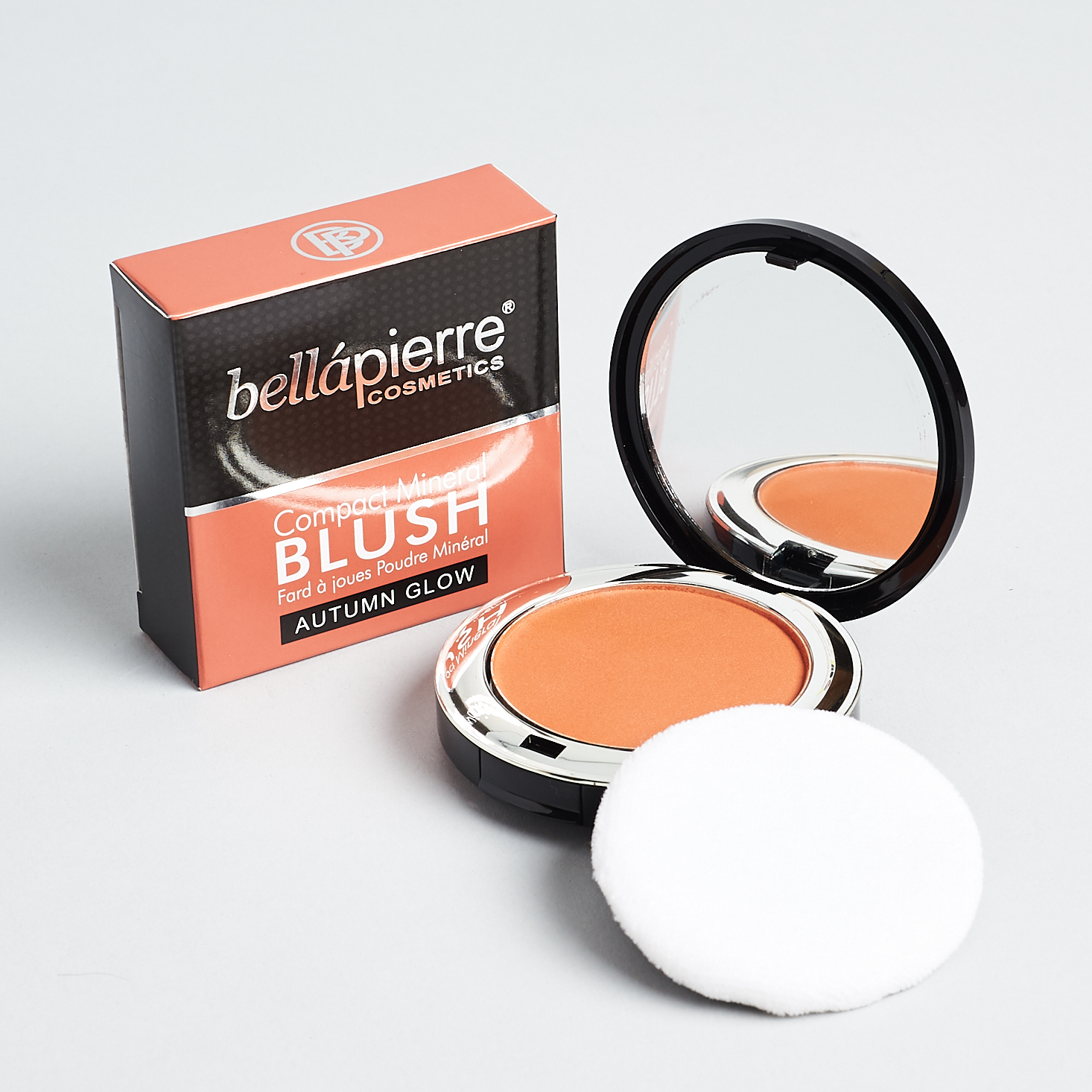 orange blush inside black and silver compact