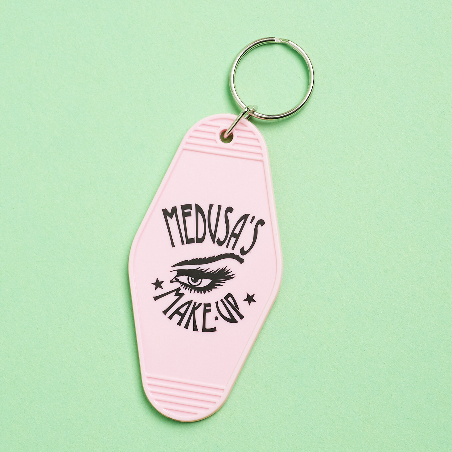 motel style keychain in light pink with logo