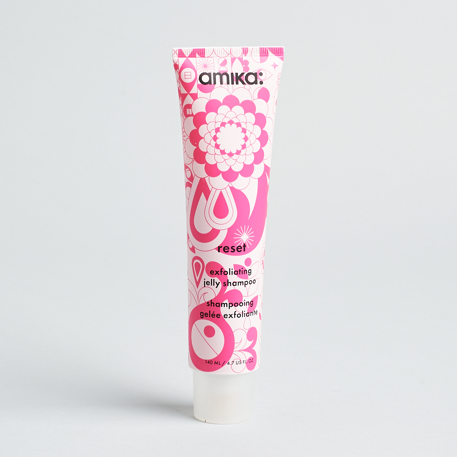 pink patterned tube of shampoo with clear cap