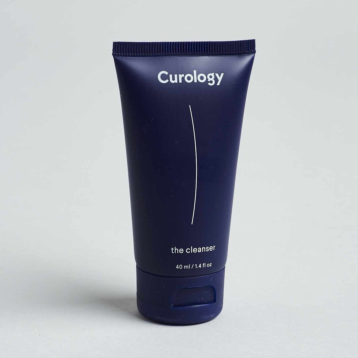 dark purple tube of cleanser with white text