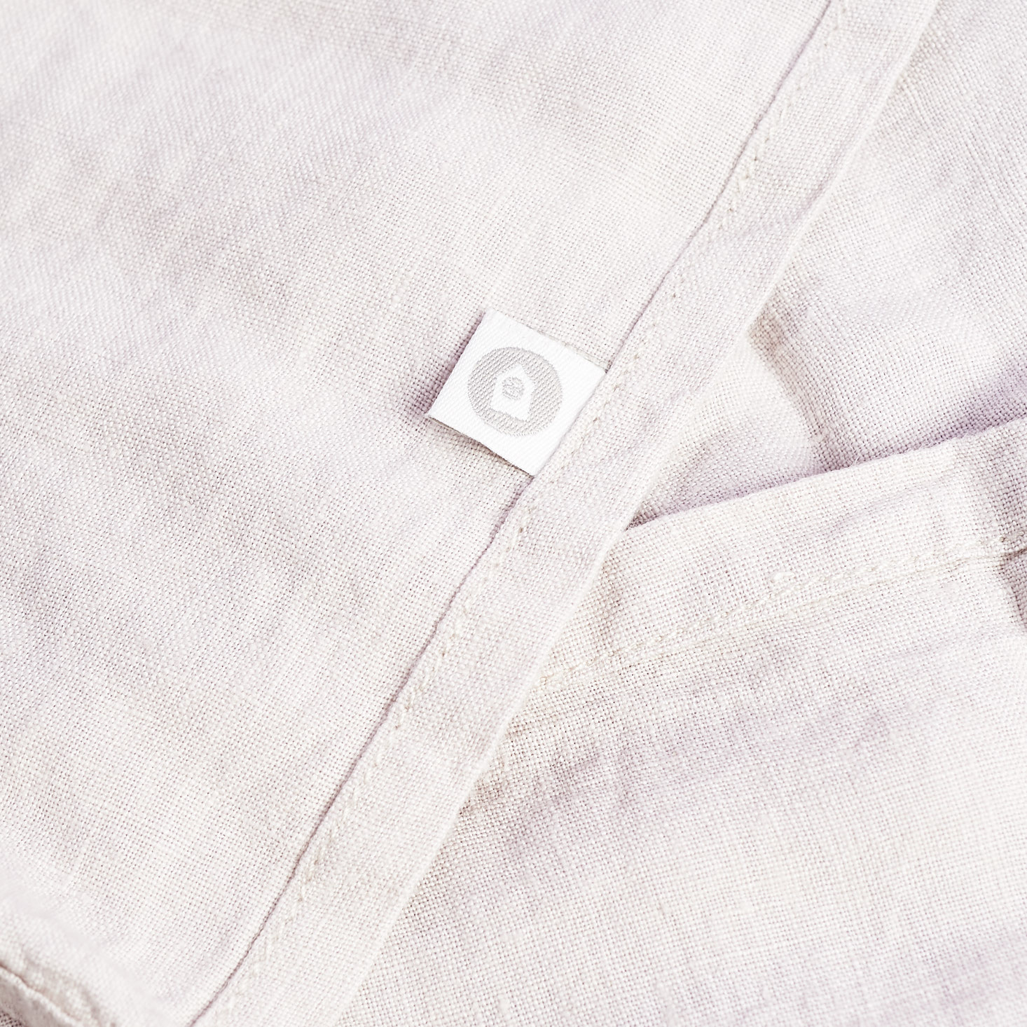 close up of linen napkin and house doctor tag