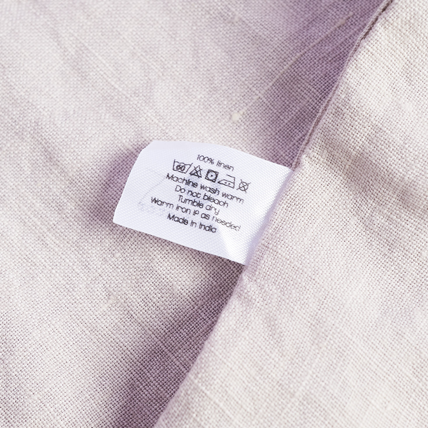 close up of linen napkin and care tag