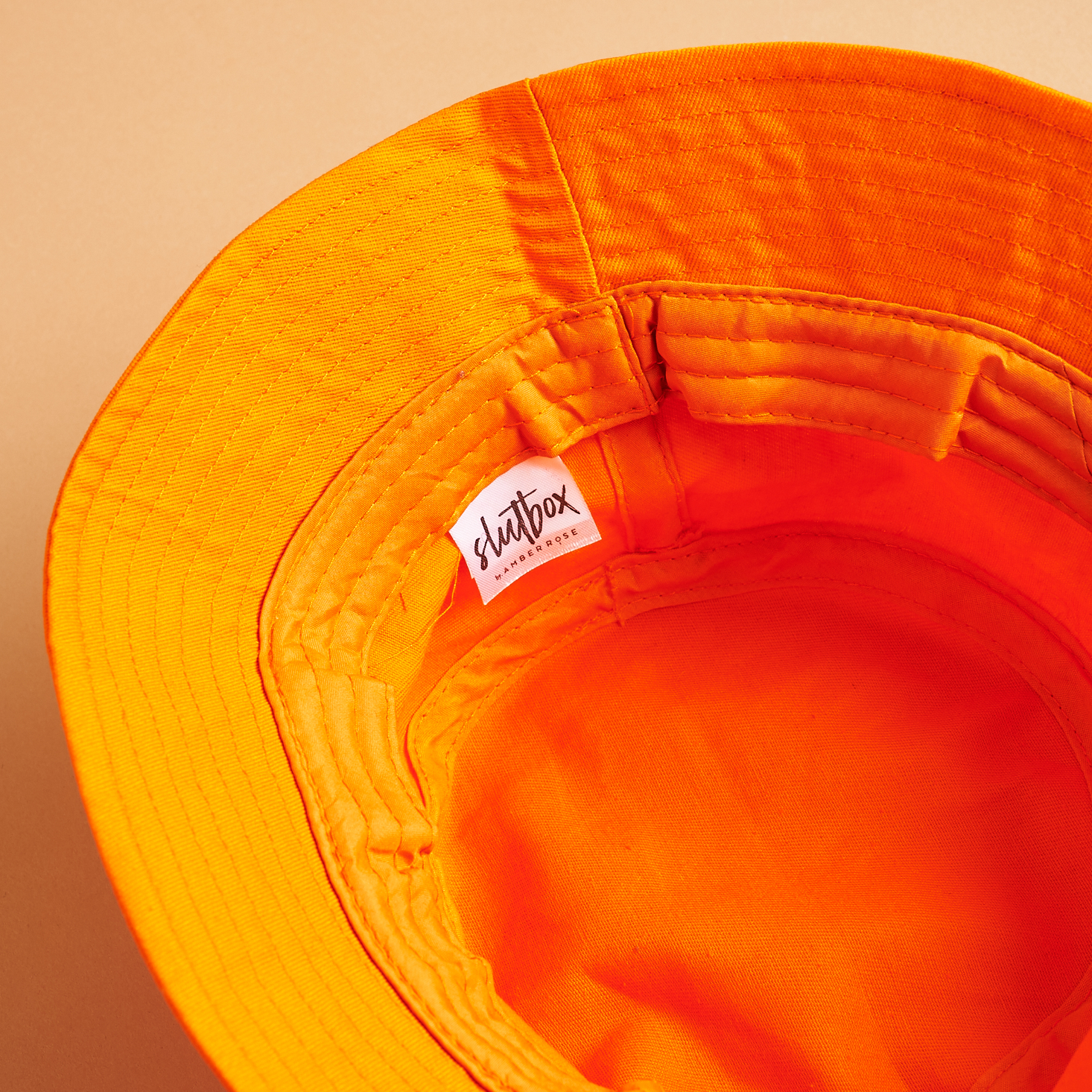 tag inside Orange SlutBox Bucket Hat