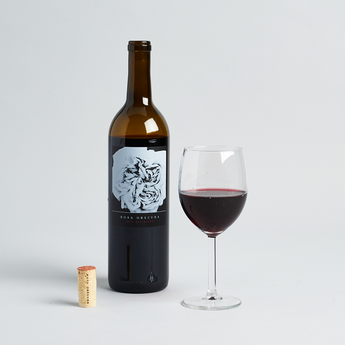 rosa obscura red blend opened bottle and glass with cork