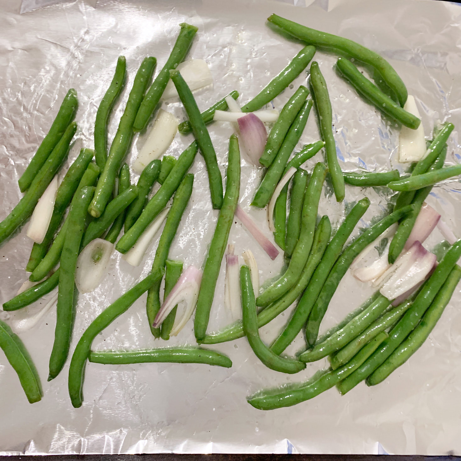 Green beans and shallots on baking sheet