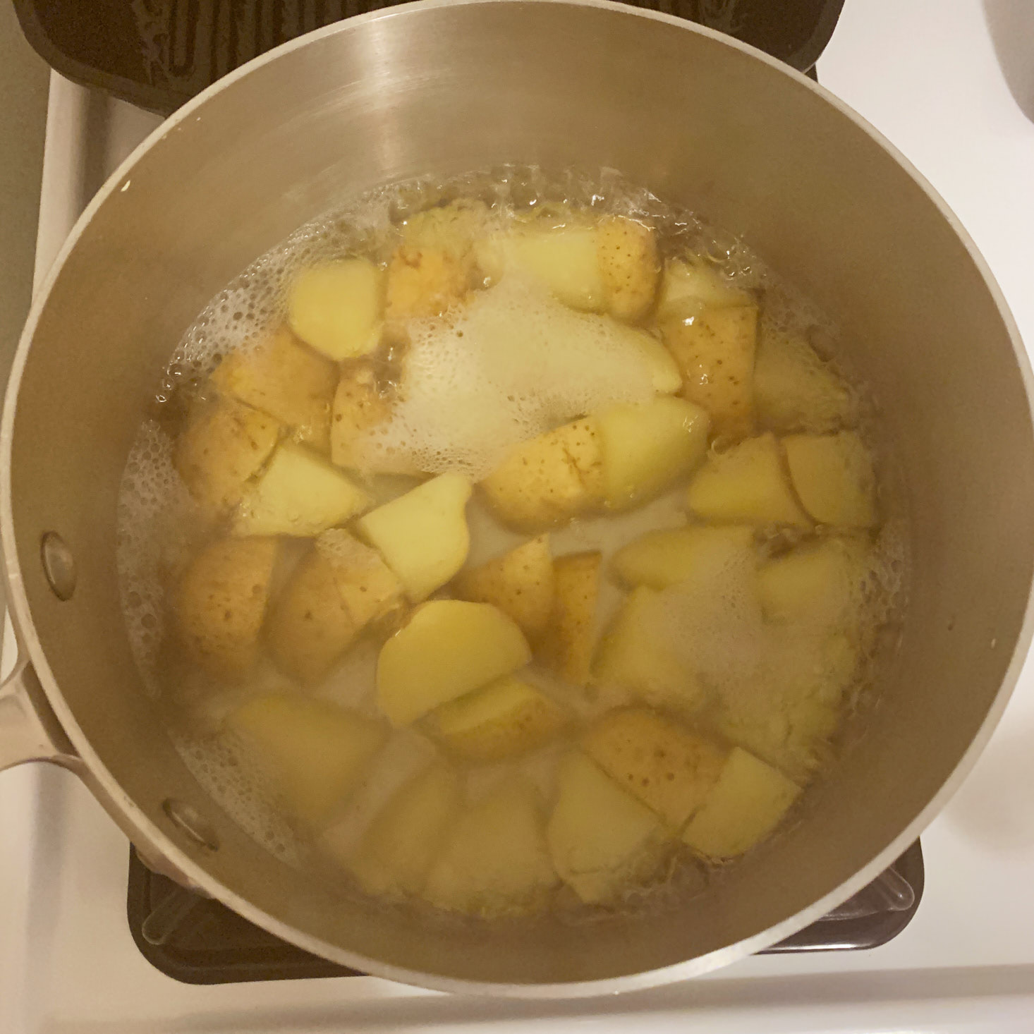 potatoes cooking in pot of water