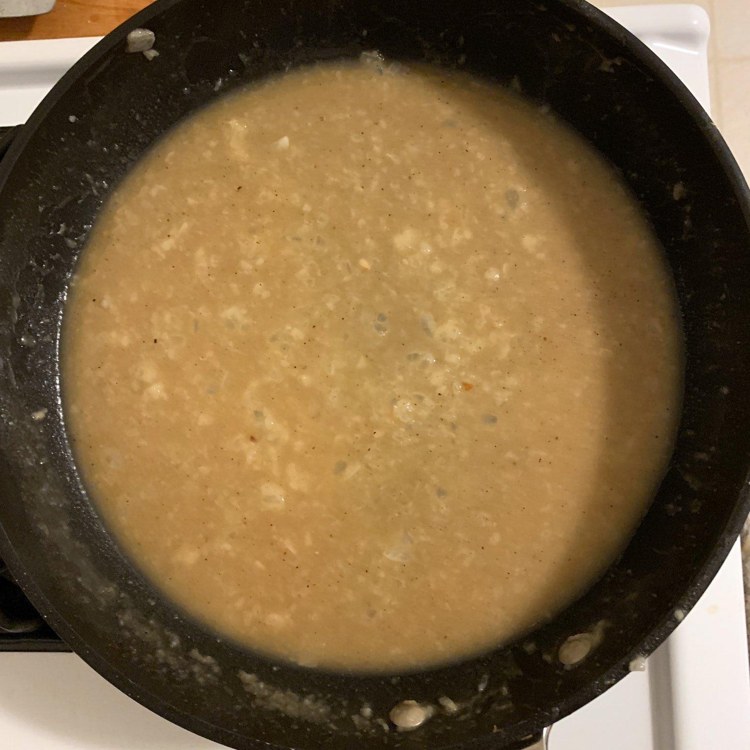 stock and water added to sauce in pan