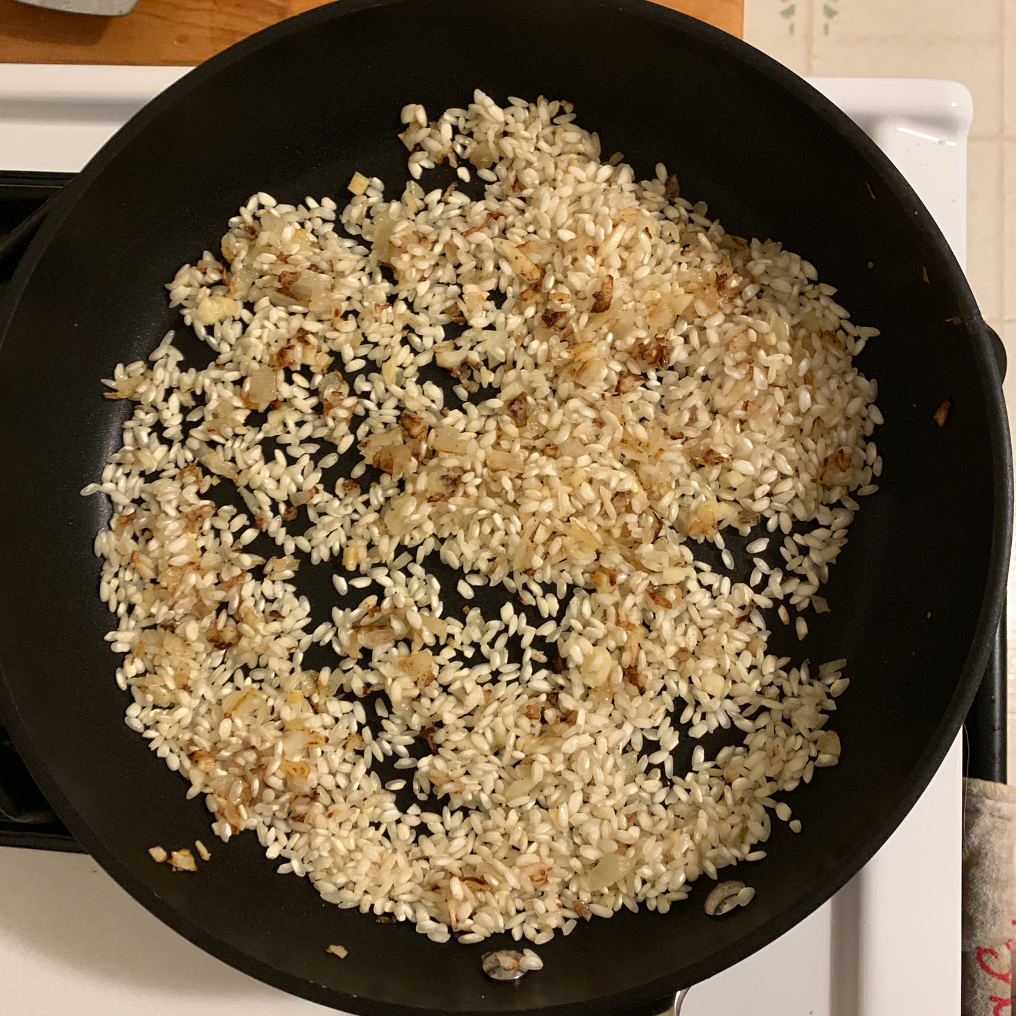 Dry risotto in pan with garlic and onion