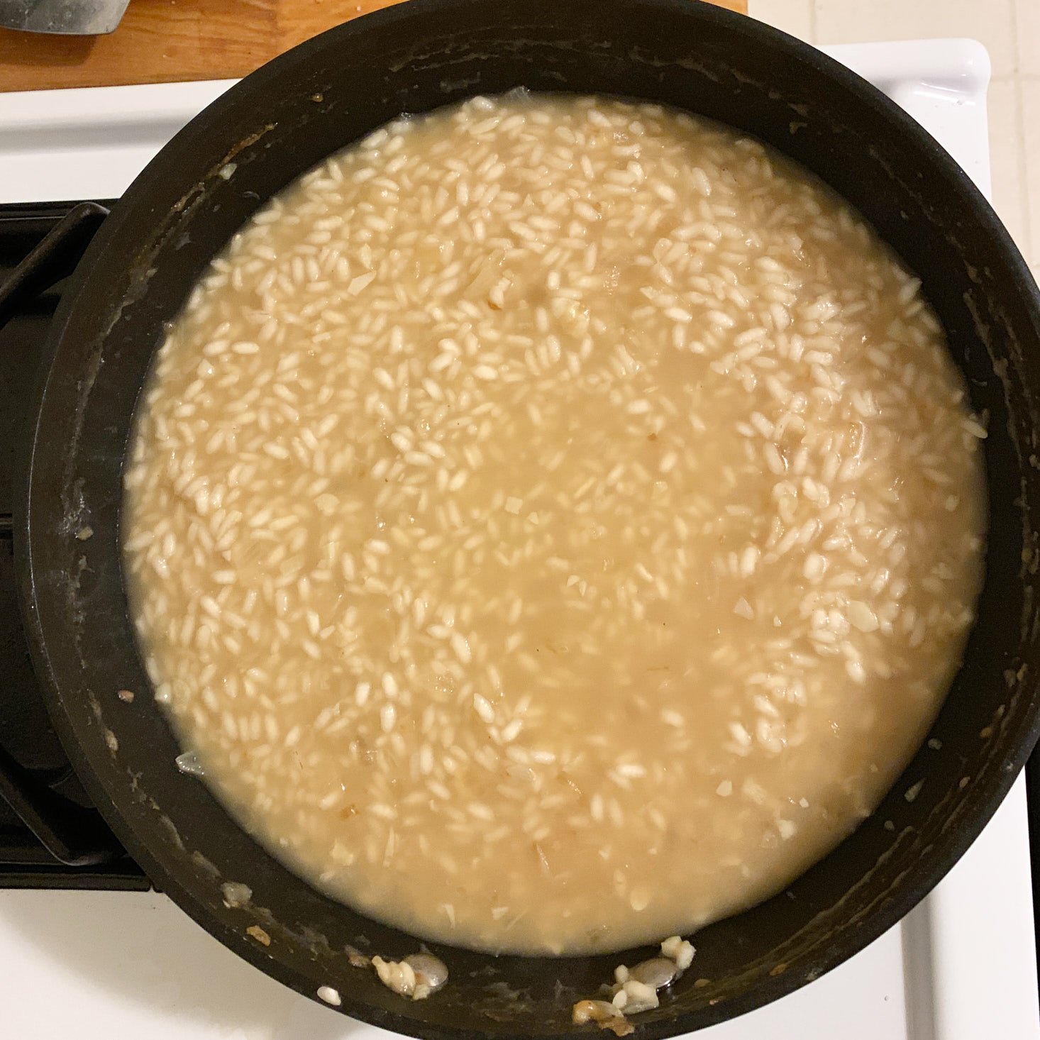 water and stock added to risotto in pan