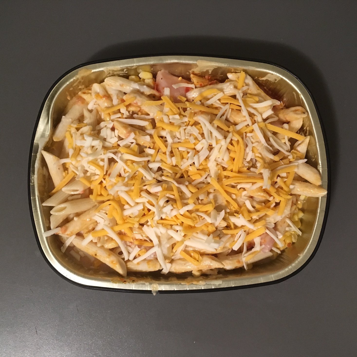 chipotle chicken alfredo baked penne topped with cheese